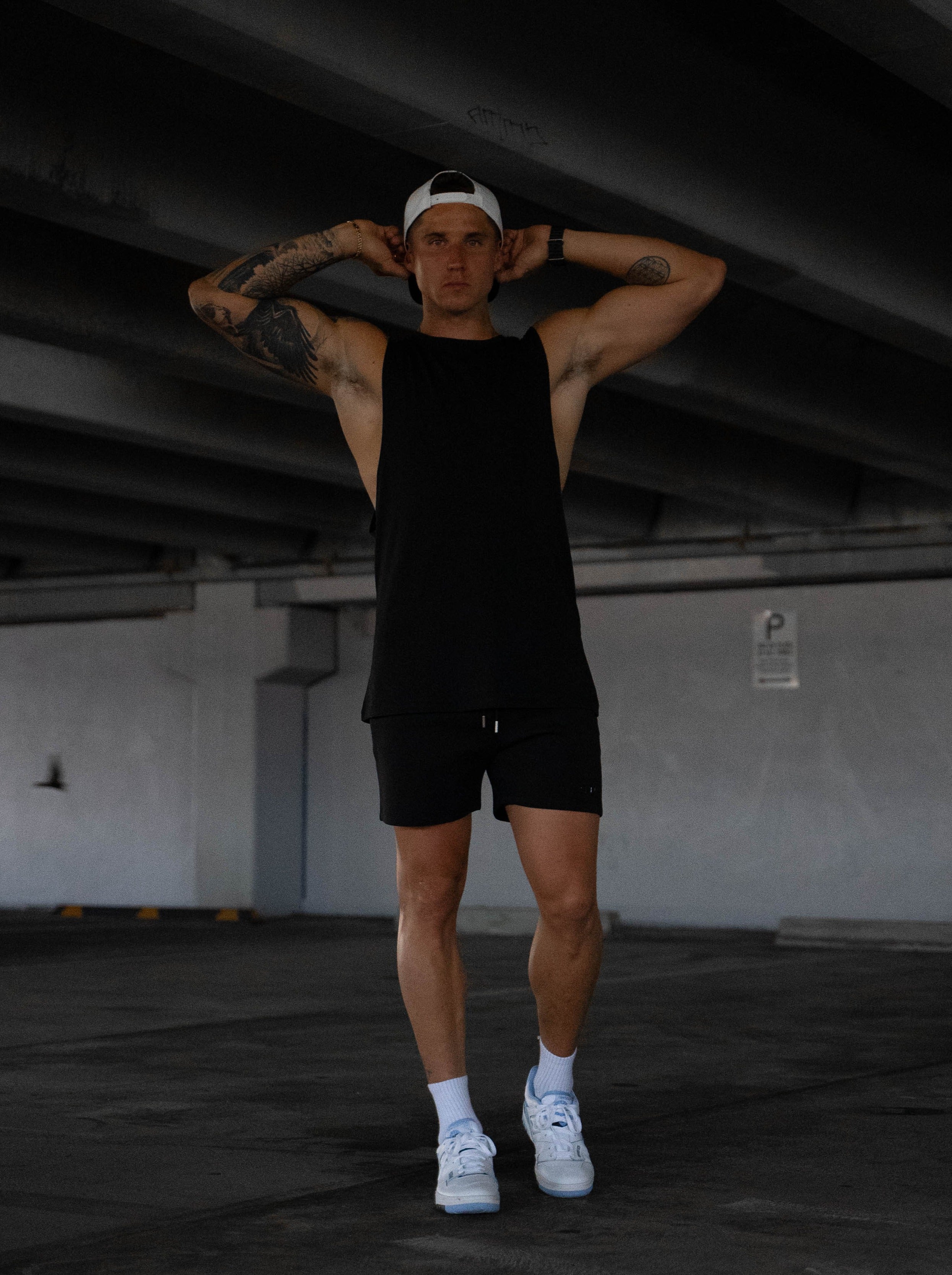 Connor wears a size XL Tank in this shot