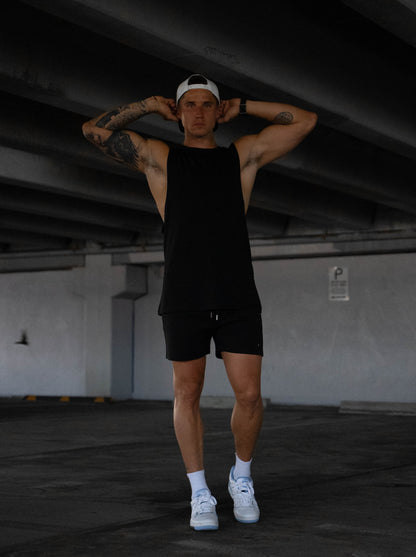 Connor wears a size XL Tank in this shot